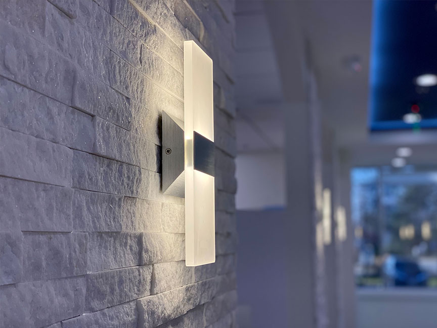 A wall-mounted, rectangular light fixture with a frosted glass finish.