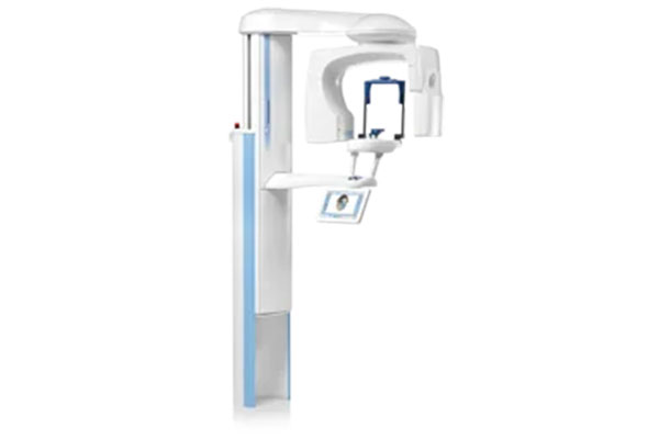 Digital X-ray machine with a monitor displaying an image, situated in a medical or dental setting.