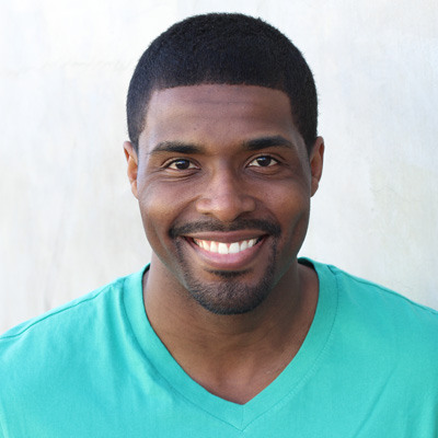 An elderly couple embracing, smiling and posing for a photo.